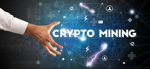 Hand pointing at CRYPTO MINING inscription, modern technology concept
