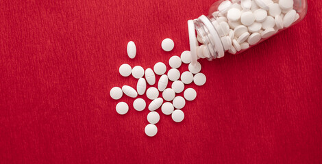 Fototapeta na wymiar Medical concept, white pills on red background.