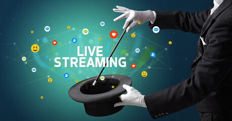 Magician is showing magic trick with LIVE STREAMING inscription, social media marketing concept