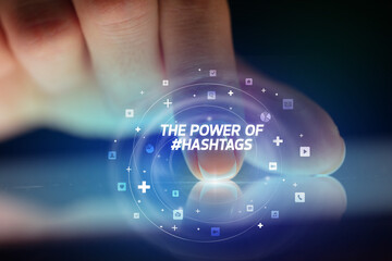 Finger touching tablet with social media icons and THE POWE OF #HASHTAGS