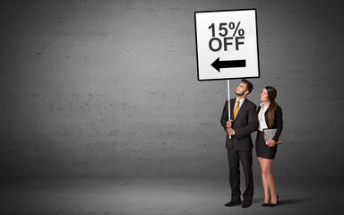 business person holding a traffic sign with 15% OFF inscription, new idea concept