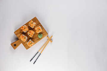 Appetizing rolls on a white background. Japanese food concept. Close-up. Copy space. Flat lay.