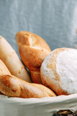 Bread assortment of French baguette and rye bread. Bread basket close-up.