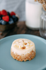 Chocolate dessert with soft milk cream. Tartlet with chocolate chips on a wooden background.