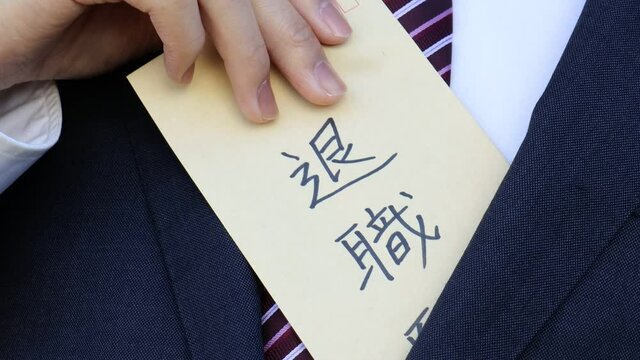 退職願を持つスーツを着た男性