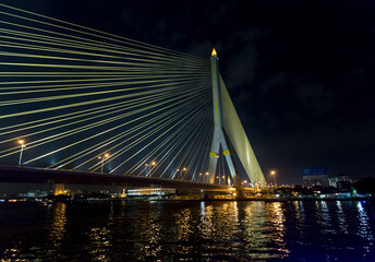 King Rama VIII bridge over Chao Phraya River at night in Bangkok, Thailand