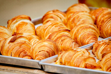 Closed up delicious croissant bakery in they tray after cooked and get out from the oven