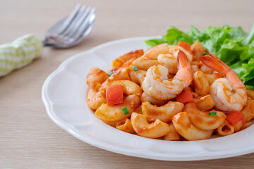 Stir fried macaroni with shrimp and vegetable on plate.