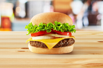 a beef burger in the wooden table with a background modern of restaurant
