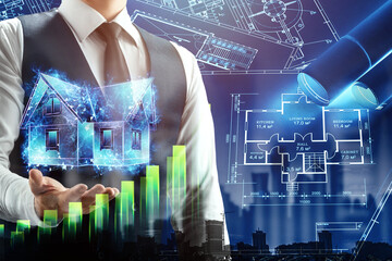A businessman holds on his hand a hologram of a house against the background of blue construction drawings. The concept of construction, mortgage, affordable housing. Mixed environment.