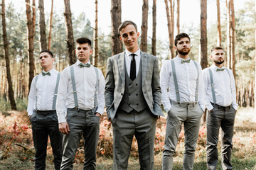 group wedding photo of a handsome groom with his wonderful friends, outdoor wedding, stylish guys, international wedding