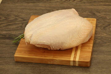 Raw whole chicken breast with skin