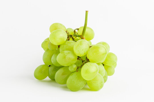One bunch of ripe organic white grapes isolated on white background, side view.