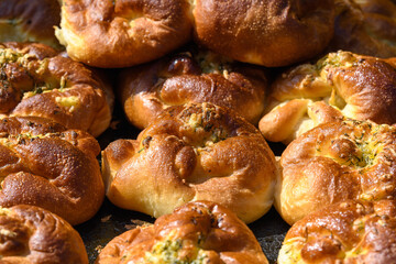 Traditional Romanian sweets knows as poale in brau, freshly homemade cheese and dill buns on display for sale at a street food market, top view of healthy food photographed with selective focus.