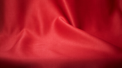 Red cloth waves texture background stage shot in table top for christmas background 