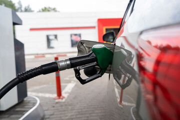 refueling gun in the gas tank, the concept of increasing fuel prices