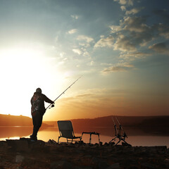 angler carp angler on the lake with fishing rods