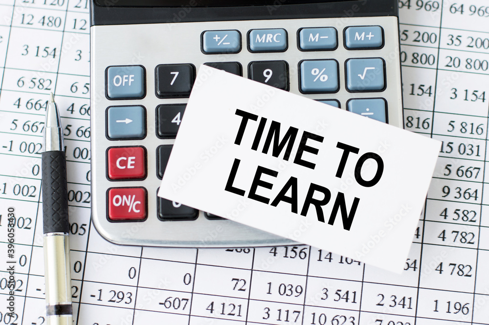 Poster business card with text time to learn, which lies on the calculator,pen and financial statements on 