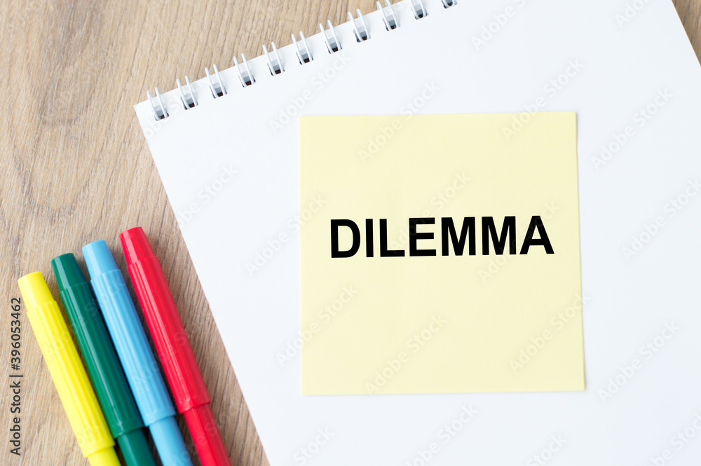 Poster the inscription on the yellow sheet for notes text dilemma which is attached to the notebook on the 