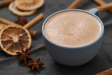 Hot chocolate in a blue cup with natural christmas decorations