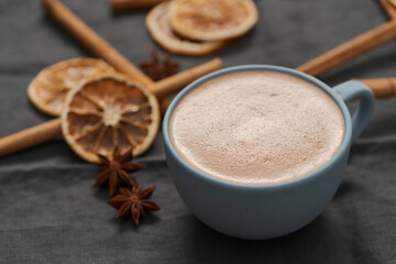 Hot chocolate in a blue cup with natural christmas decorations