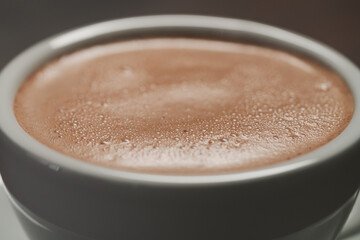 closeup of hot cocoa drink on walnut wood table