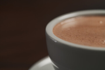 closeup of hot cocoa drink on walnut wood table