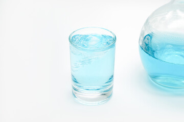 blue alcoholic drink in a decanter. Cocktail with blue gin , tonic