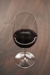 Red wine in wineglass on black walnut table