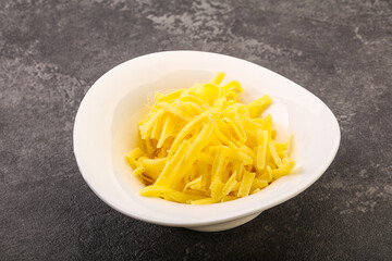 Shredded yellow cheese in the bowl