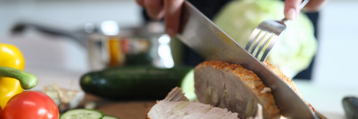 Hands chop ready baked pork meat and vegetables. An online course on modern cooking. Choose and combine different products. Eat more fully and variably. Finish cooking meat dishes