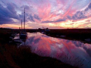 Vibrant sunset reflected over the river estuary 