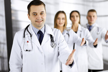 Team of friendly professional doctors are offering their helping hand for the people. Physicians are ready to help their patients. Best medicine concept nowadays