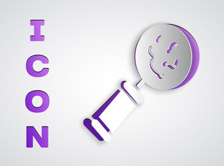 Paper cut Microorganisms under magnifier icon isolated on grey background. Bacteria and germs, cell cancer, microbe, virus, fungi. Paper art style. Vector.