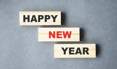 Happy New Year words on cubes on a white wooden background