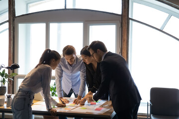 Millennial woman tutor expert consultant teaching students colleagues interns to work with...