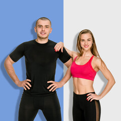 Young athletic man and woman posing after training on a split background of blue and light gray