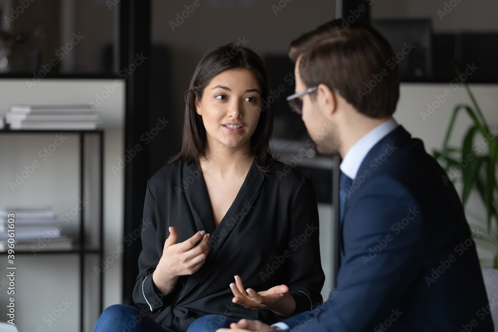 Poster concentrated millennial indian female candidate on vacant place answering question of male hr introd