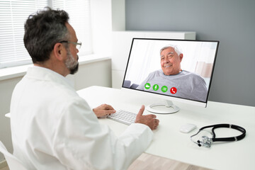 Fototapeta na wymiar Doctor Talking With Patient Online In Video Call