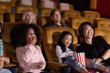 Happy family watching movie in cinema theatre. Happy family time in holiday