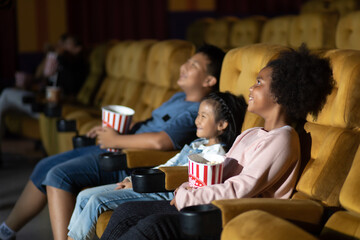 Happy family watching movie in cinema theatre. Happy family time in holiday