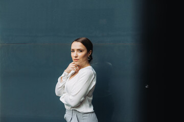 Portrait of happy business woman standing on street.