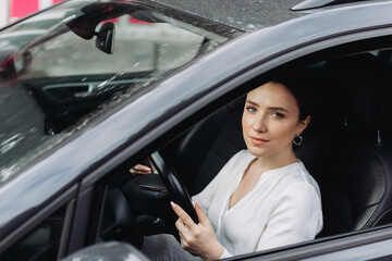 Young woman driving a car in the city.