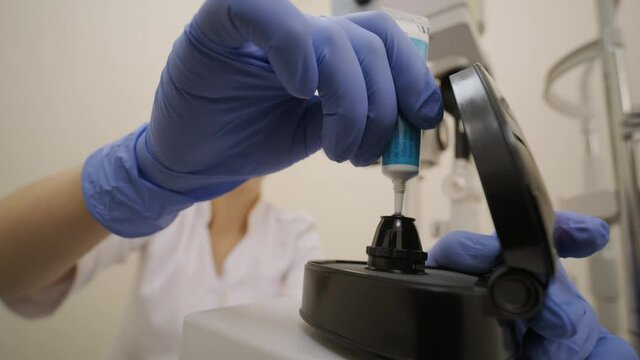 Ophthalmologist surgeon apply the gel to the surface Ophthalmoscopy Lens which is used in ophthalmic for the general diagnosis of eye diseases and specifically for Selective Laser Trabeculoplasty