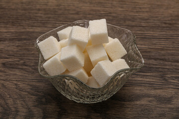 Refined white sugar cubs in the bowl
