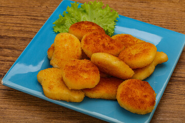 Fried chicken nuggets served salad leaves
