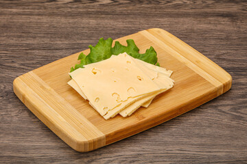 Sliced yellow cheese over board