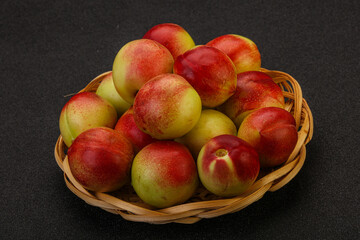 Sweet small nectarines in the basket