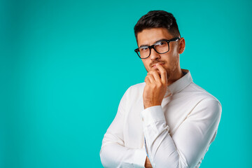 Photo of thoughtful young man touching his chin