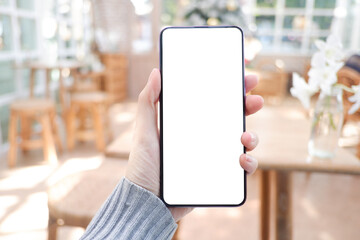 Cropped shot view of business woman’s hands holding the mobile phone with blank copy space screen for your information content or text message, the woman reading text message on the smart phone.